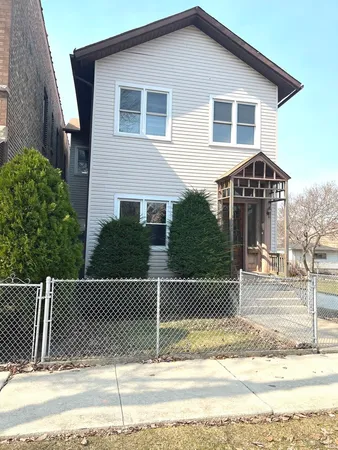 a front view of a house with a fence