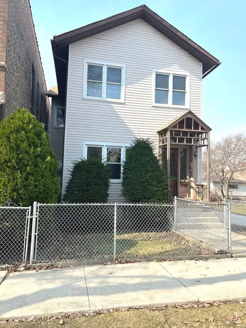 a front view of a house with a fence