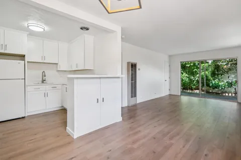 a view of a kitchen with wooden floor