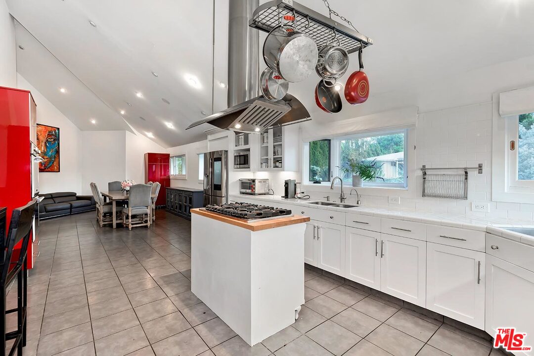 3389 Wrightview Place Studio City, CA 91604 - Photo 11 of 20 a kitchen with stainless steel appliances granite countertop a stove and cabinets