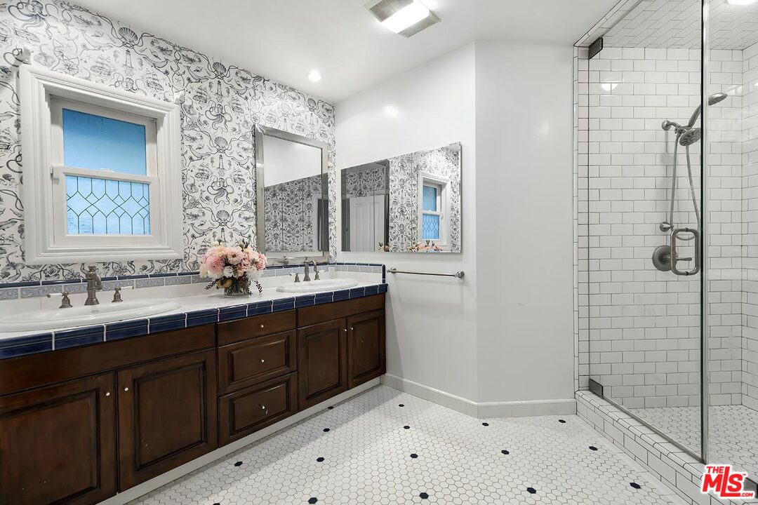 3389 Wrightview Place Studio City, CA 91604 - Photo 14 of 20 a bathroom with a double vanity sink mirror and shower