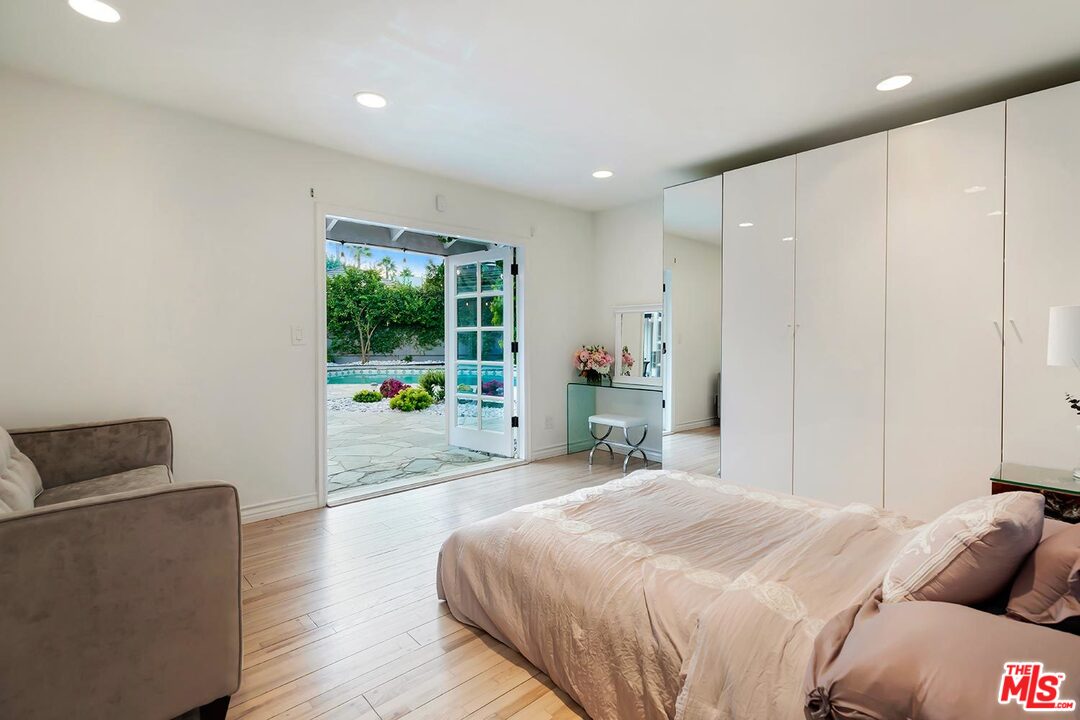 3389 Wrightview Place Studio City, CA 91604 - Photo 16 of 20 a spacious bedroom with a bed and wooden floor