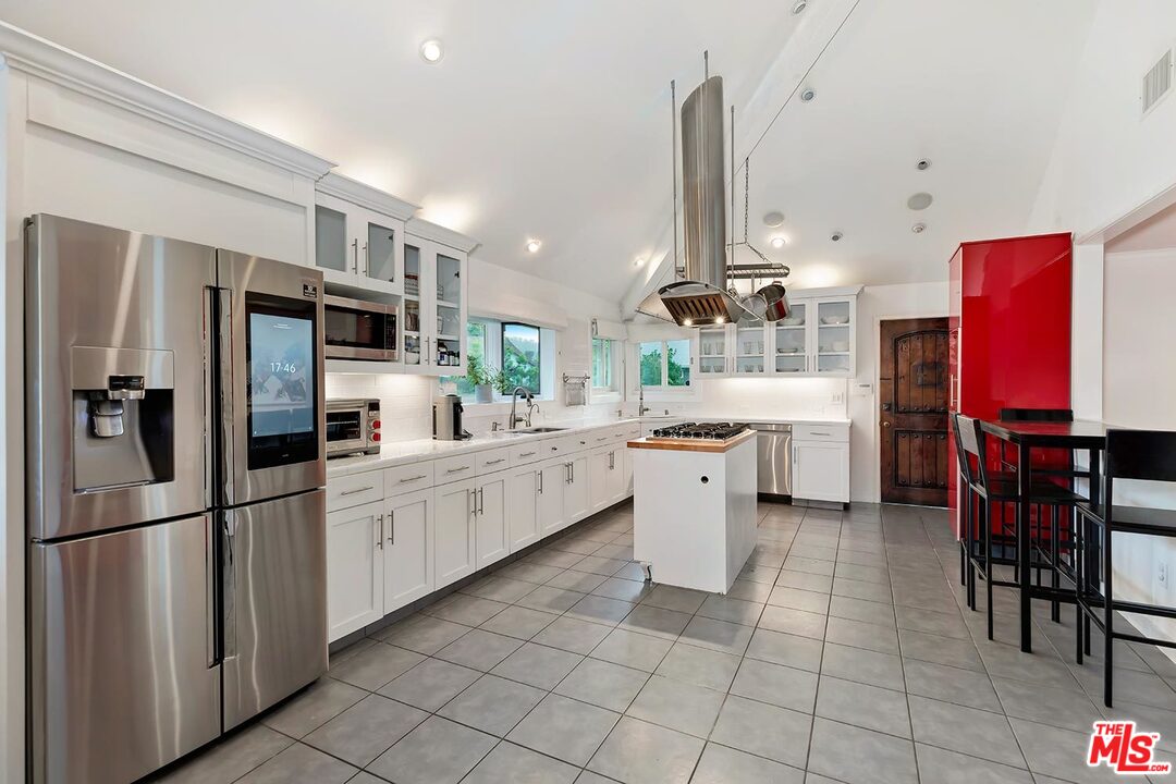 3389 Wrightview Place Studio City, CA 91604 - Photo 9 of 20 a kitchen with stainless steel appliances a refrigerator sink and cabinets