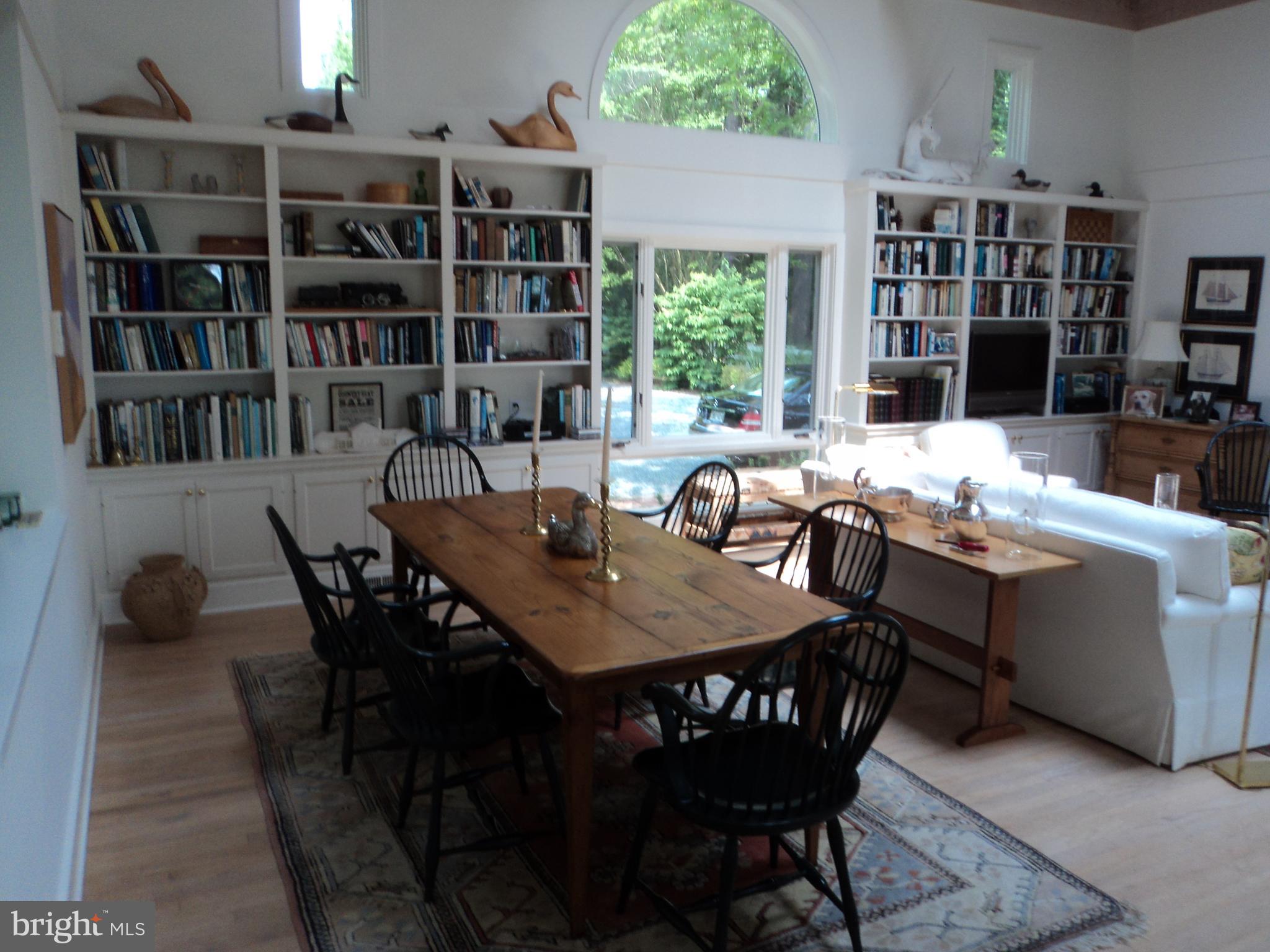 23452 Pine Point Road, Unit 23452 Bozman, MD 21612 - Photo 16 of 30 great room with dining area and built-in bookcases