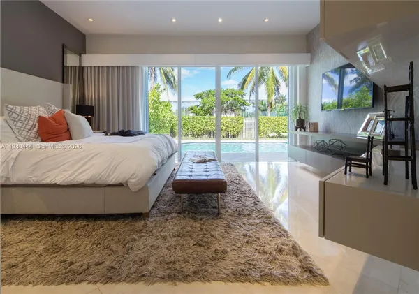 a bedroom with a large bed and a large window