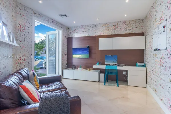 a living room with furniture a fireplace and a flat screen tv