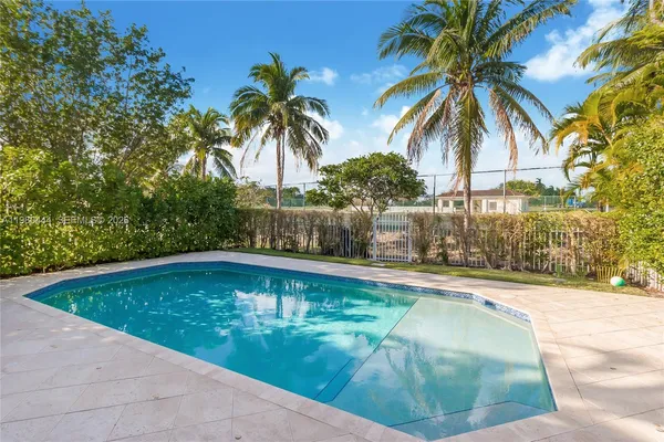 a view of swimming pool with outdoor seating and plants