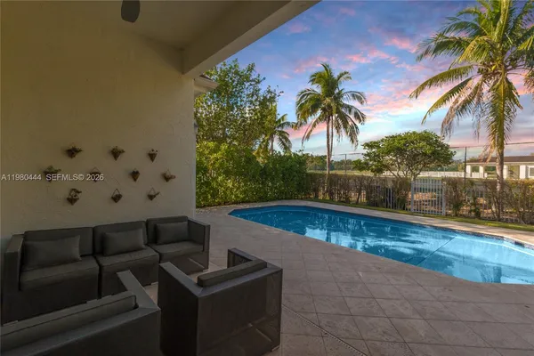 a view of swimming pool with outdoor seating and plants