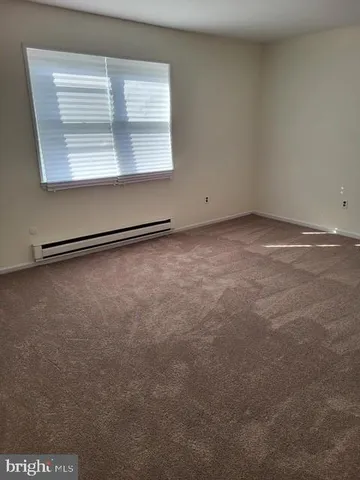 an empty room with a empty space and windows