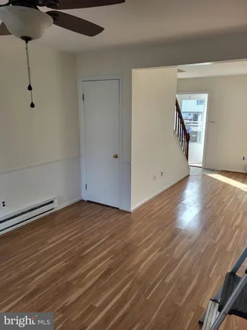 a view of an empty room with wooden floor