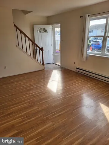 a view of room with window and wooden floor