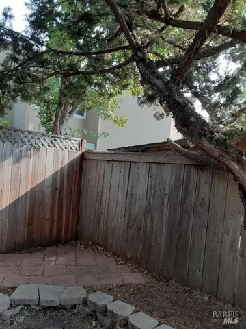 a view of a backyard with wooden fence