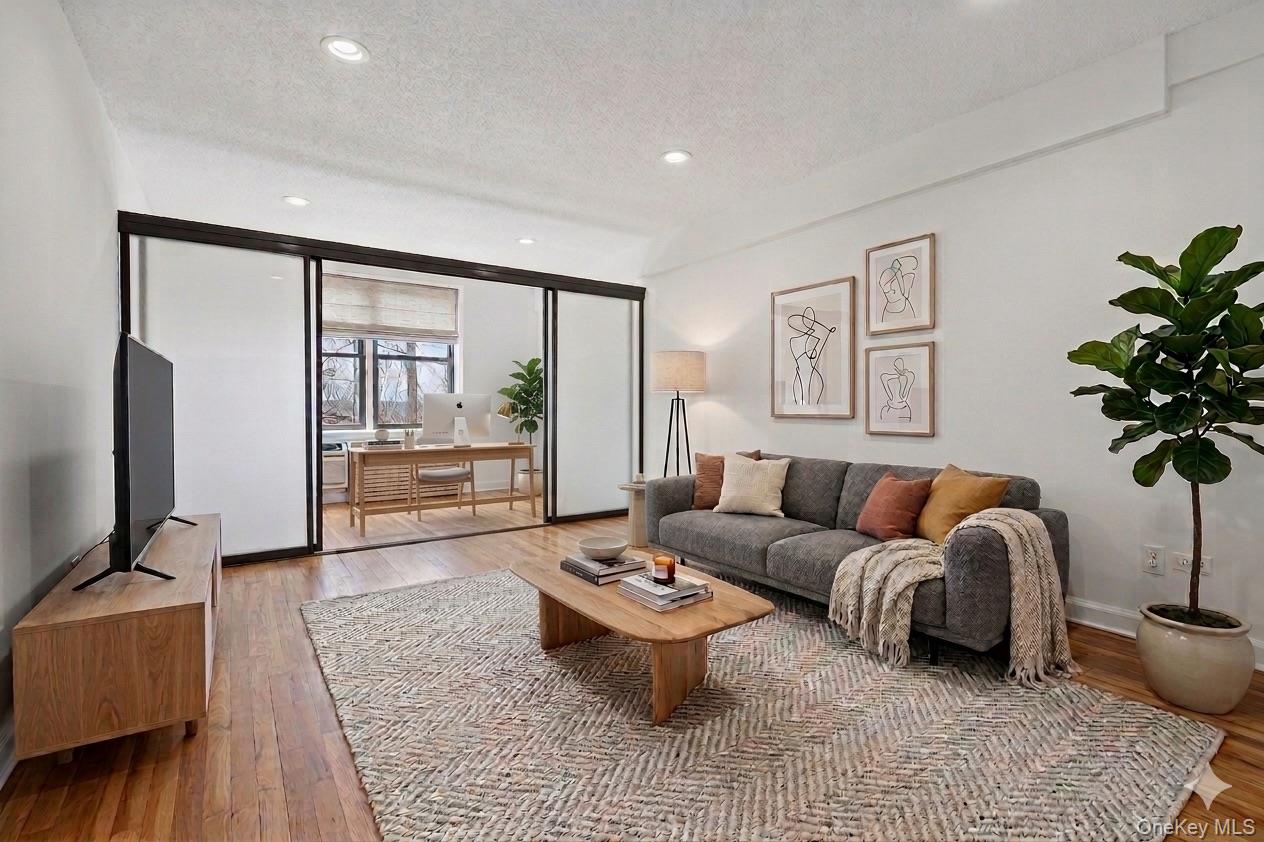 Virtually staged living room with office set up