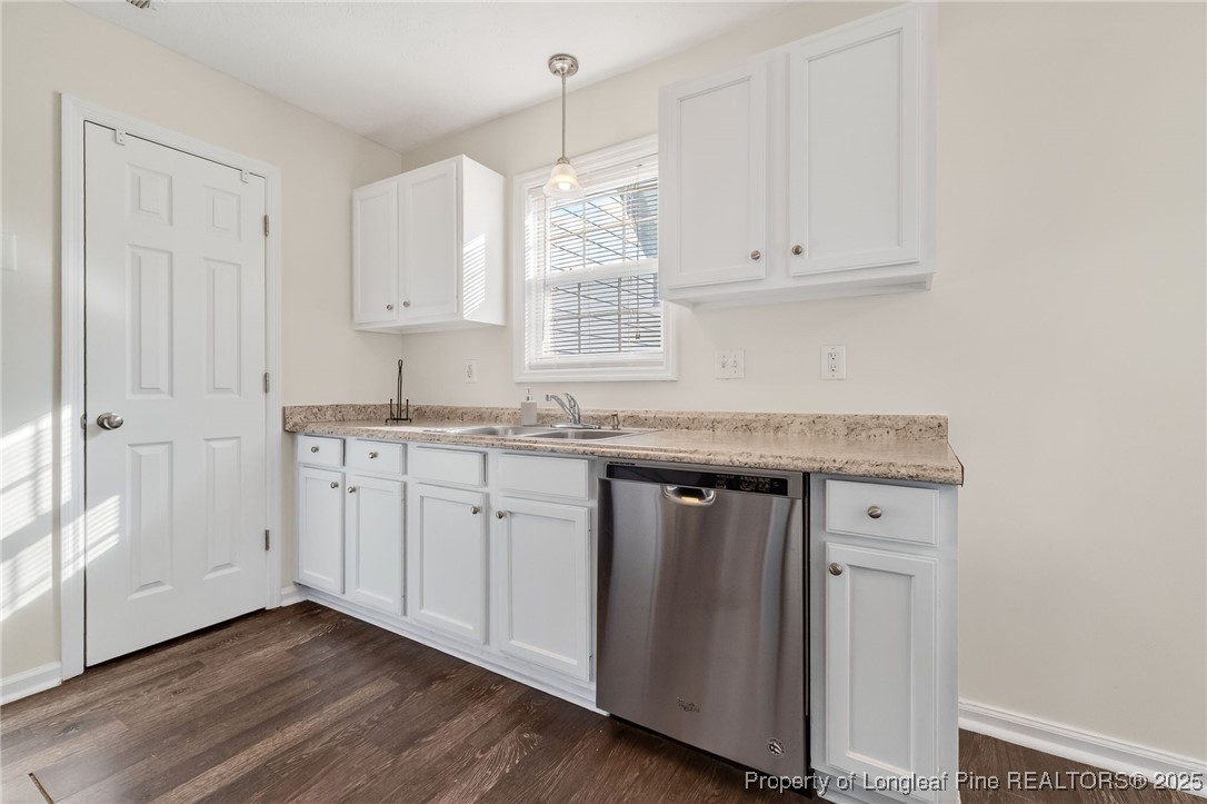 240 Rock Harbor Lane Spring Lake, NC 28390 - Photo 12 of 35 a kitchen with stainless steel appliances granite countertop a sink dishwasher and white cabinets with wooden floor