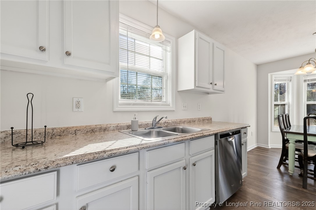 240 Rock Harbor Lane Spring Lake, NC 28390 - Photo 14 of 35 a kitchen with granite countertop a sink a center island and cabinets