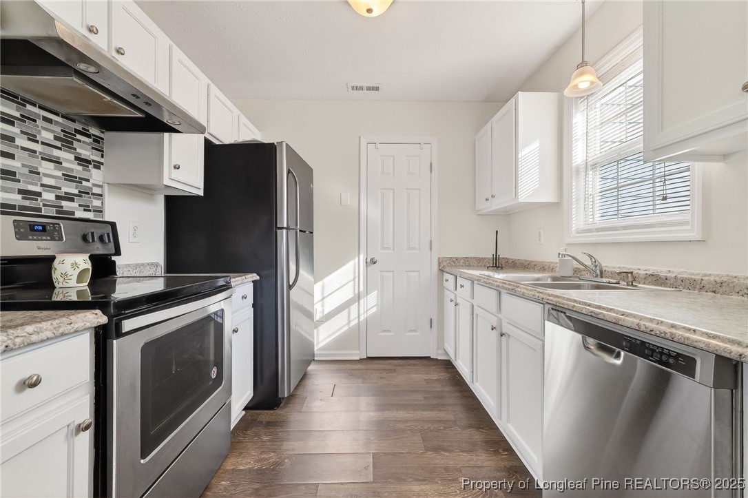 240 Rock Harbor Lane Spring Lake, NC 28390 - Photo 16 of 35 a kitchen with stainless steel appliances granite countertop a stove a sink and a refrigerator