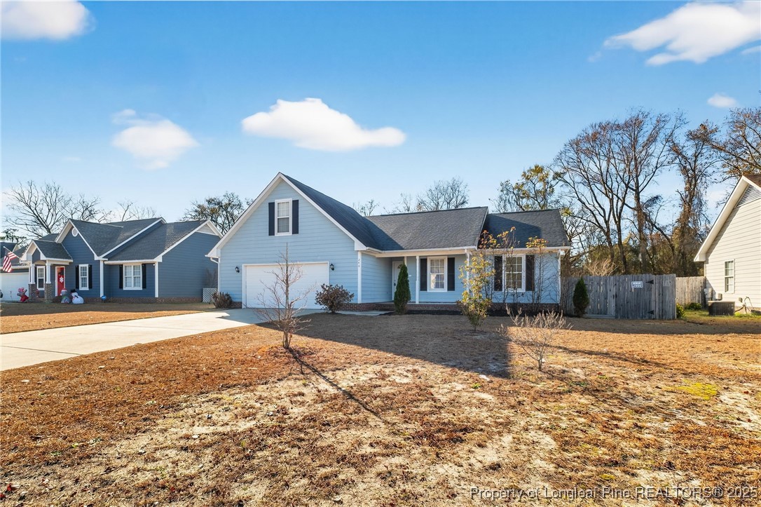 240 Rock Harbor Lane Spring Lake, NC 28390 - Photo 2 of 35 a front view of a house with a yard and garage