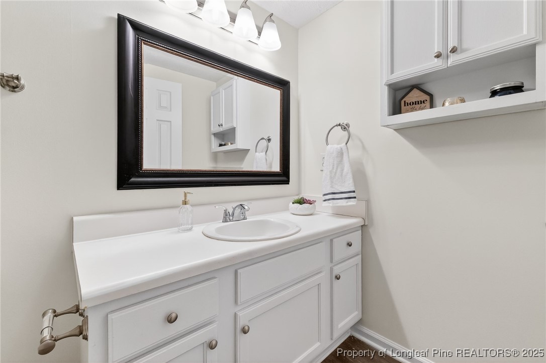 240 Rock Harbor Lane Spring Lake, NC 28390 - Photo 24 of 35 a bathroom with a sink vanity and mirror