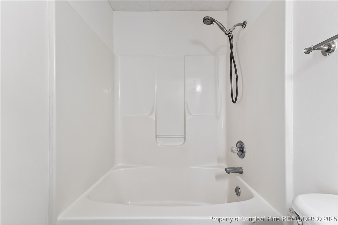 240 Rock Harbor Lane Spring Lake, NC 28390 - Photo 25 of 35 a white bath tub sitting next to a white sink and a shower