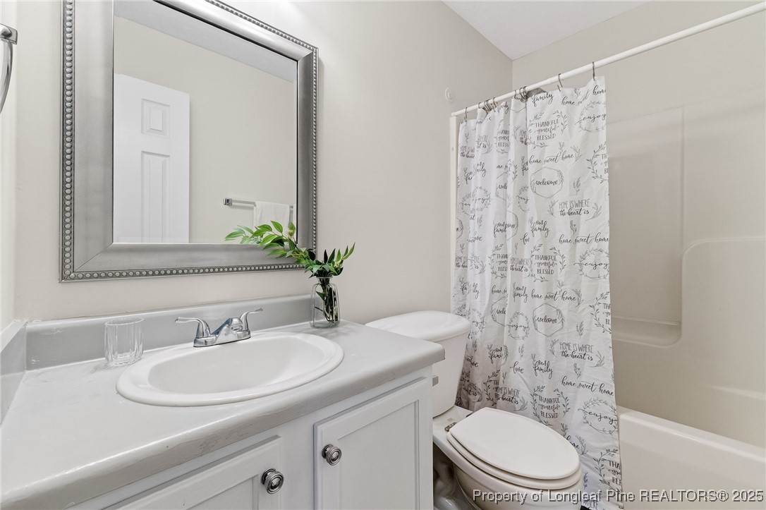240 Rock Harbor Lane Spring Lake, NC 28390 - Photo 26 of 35 a bathroom with a sink a toilet and shower