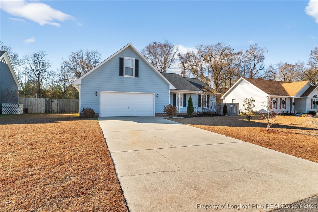 240 Rock Harbor Lane Spring Lake, NC 28390 - Photo 3 of 35 a house with tree in front of it