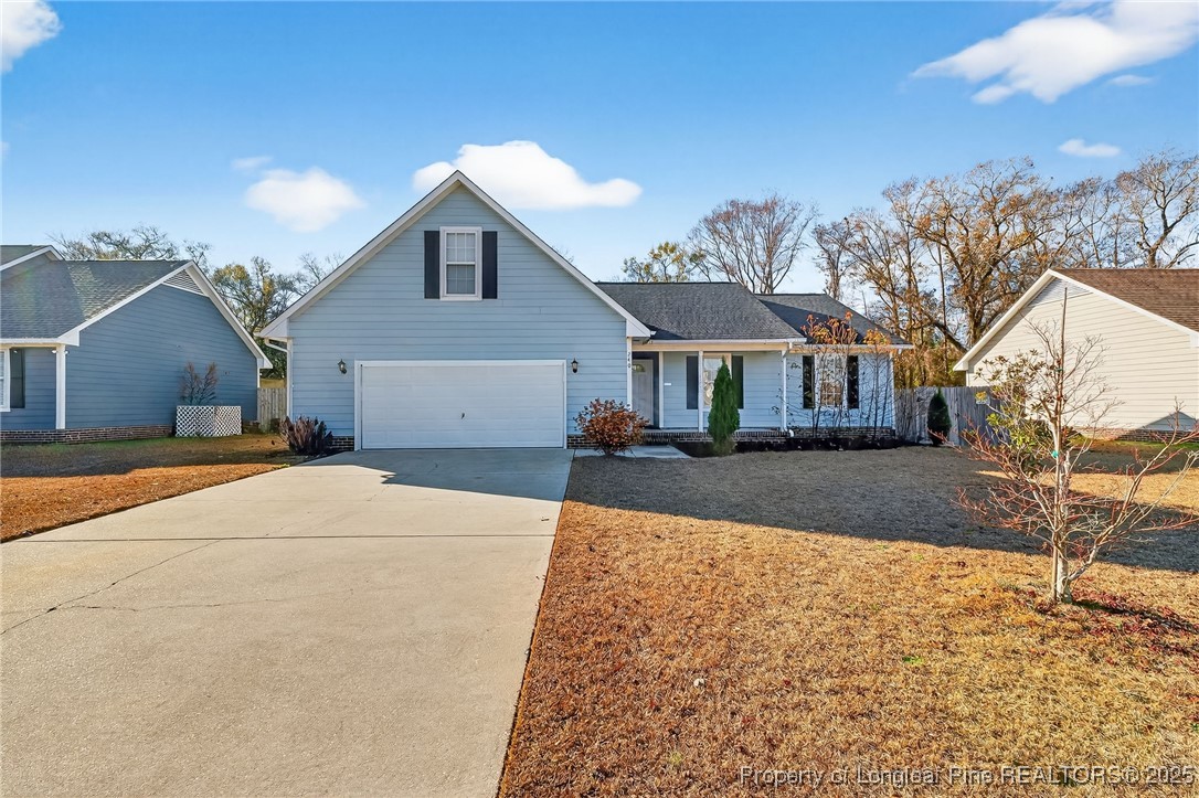 240 Rock Harbor Lane Spring Lake, NC 28390 - Photo 4 of 35 a front view of a house with a yard and garage