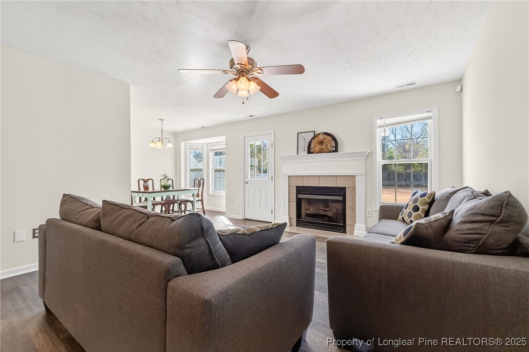 240 Rock Harbor Lane Spring Lake, NC 28390 - Photo 6 of 35 a living room with furniture a fireplace and a large window