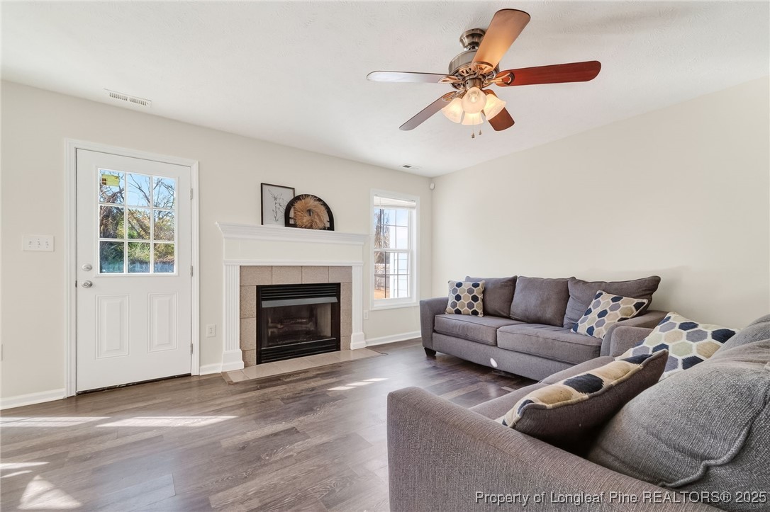 240 Rock Harbor Lane Spring Lake, NC 28390 - Photo 7 of 35 a living room with furniture a window and a fireplace