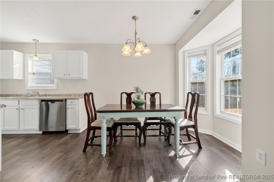 240 Rock Harbor Lane Spring Lake, NC 28390 - Photo 10 of 35 a view of a dining room with furniture window and wooden floor