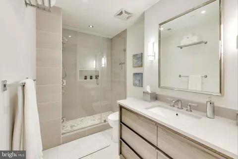 a bathroom with a shower sink and mirror