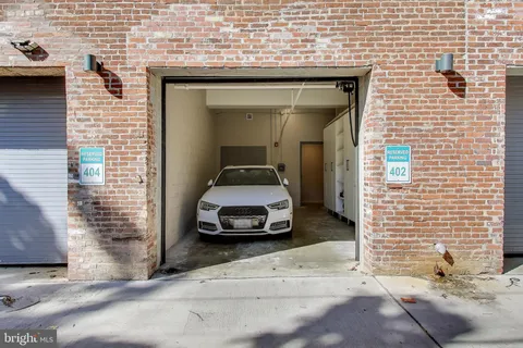 a car parked in front of a brick house