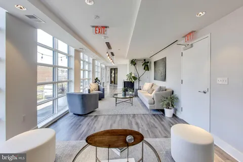 a living room with furniture a table and wooden floor