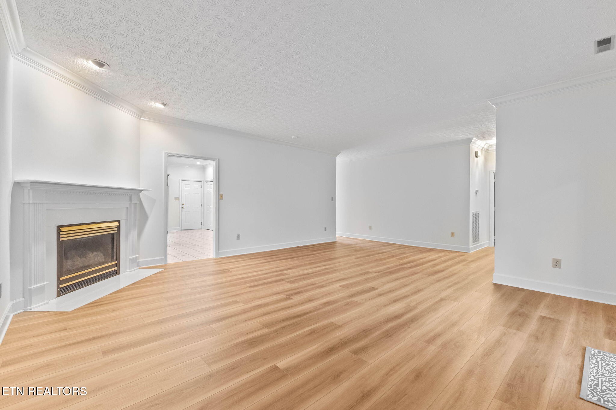 14 Rivers Court Oak Ridge, TN 37830 - Photo 9 of 30 a view of empty room with wooden floor and fireplace