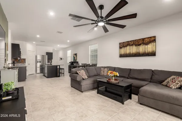 a living room with furniture and kitchen view