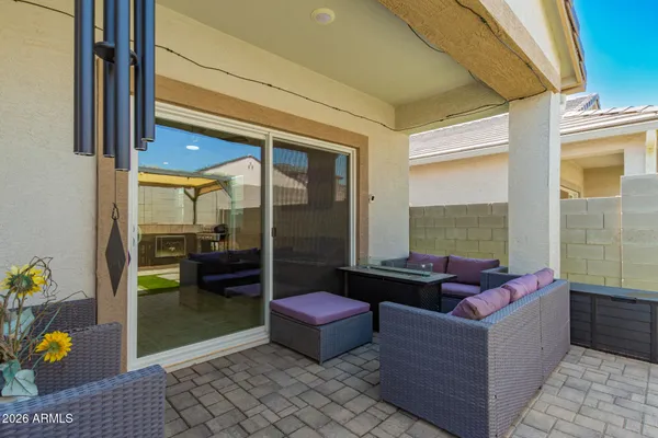 a living room with furniture and a floor to ceiling window