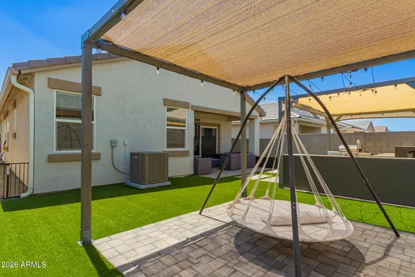 a view of an house with backyard and a slide