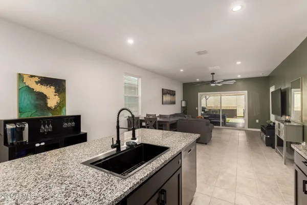a kitchen with sink and view of living room