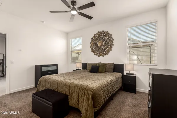 a bedroom with a bed and a chandelier