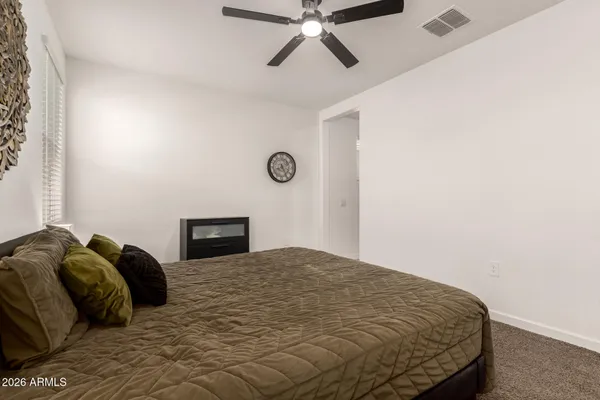 a bedroom with a bed and cabinet
