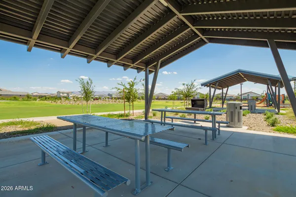 a view of a swimming pool with a lawn chairs and swimming pool