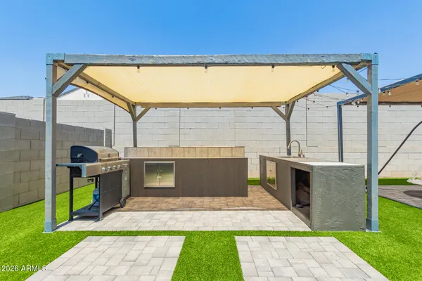 a front view of a house with a garden and yard