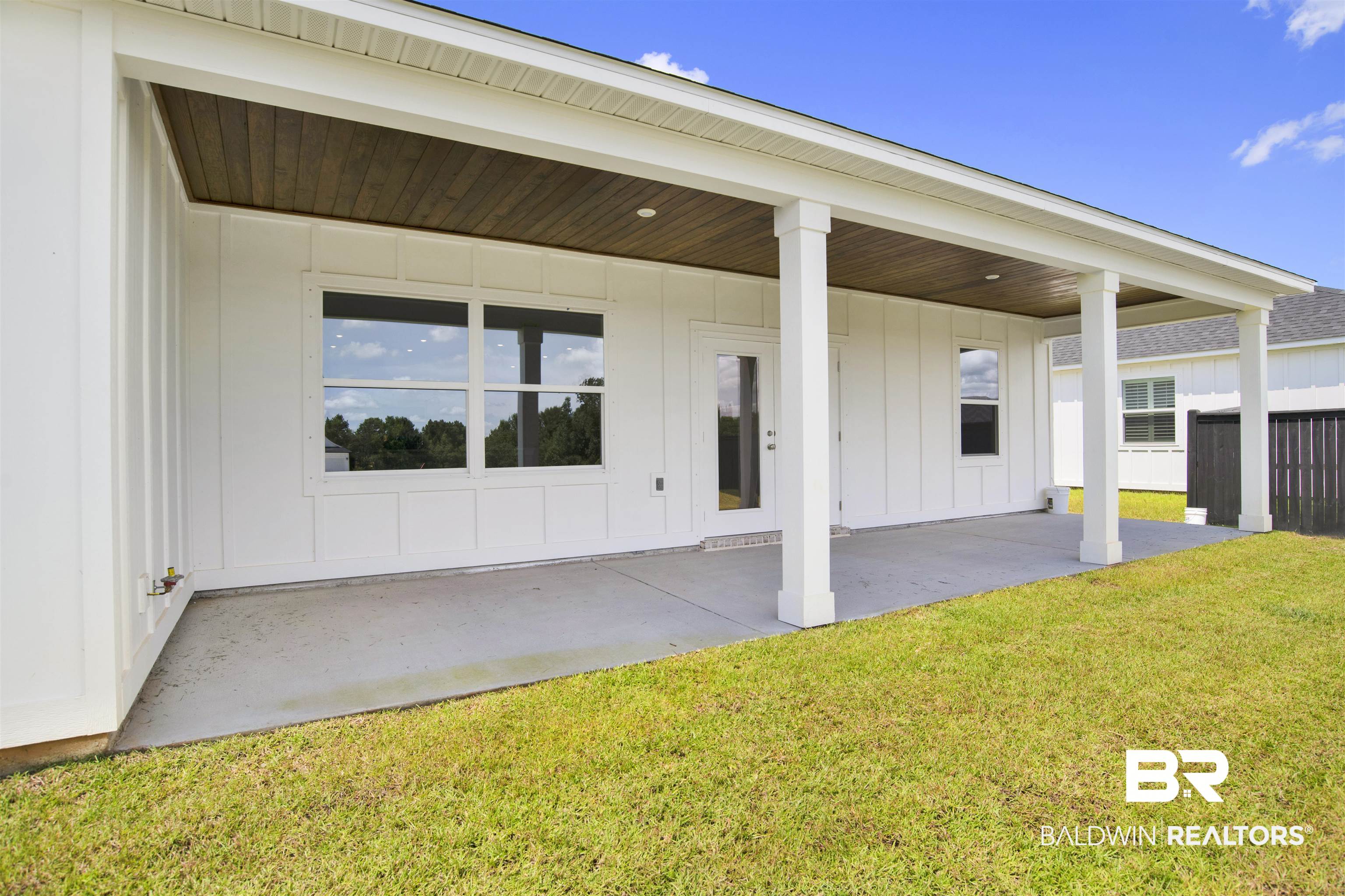23852 Lafite Circle Daphne, AL 36526 - Photo 27 of 30 Back of house with board and batten siding and a patio area