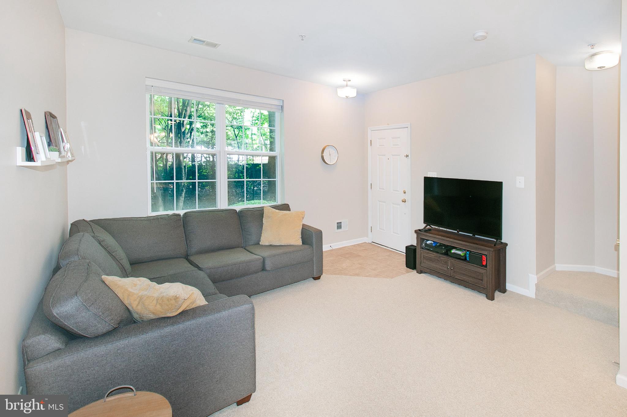 12426 Liberty Bridge Road Fairfax, VA 22033 - Photo 12 of 28 a living room with furniture and a flat screen tv
