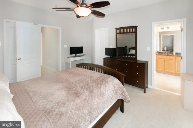 a bedroom with a bed and a flat tv screen on dresser