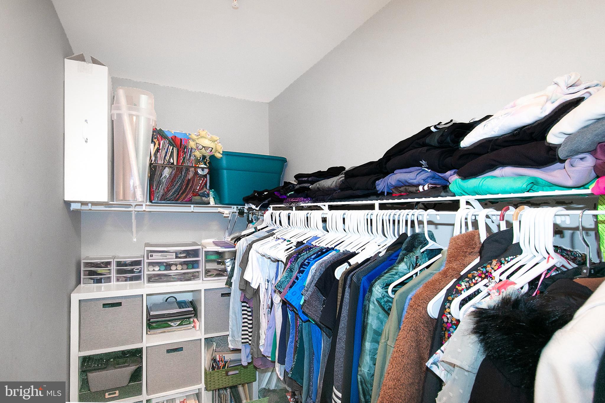 12426 Liberty Bridge Road Fairfax, VA 22033 - Photo 20 of 28 a view of walk in closet with clothes and shoes