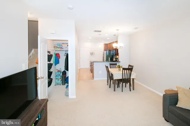 a dining room with furniture and a flat screen tv
