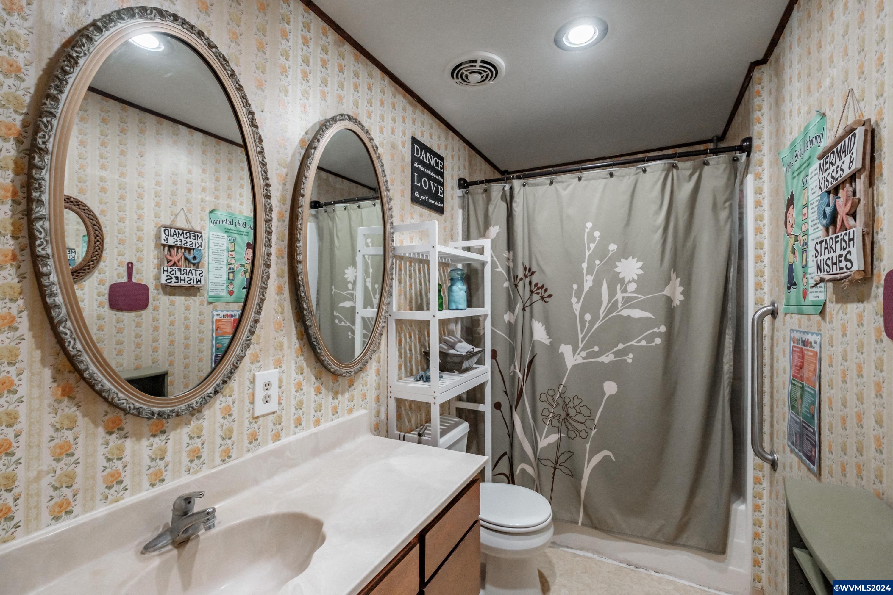 4550 Knox Butte Road East Albany, OR 97322 - Photo 19 of 49 a bathroom with a toilet sink and mirror