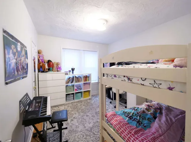 a kitchen with stainless steel appliances wooden floor and dining table