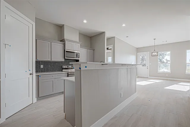 a kitchen with refrigerator cabinets and a sink