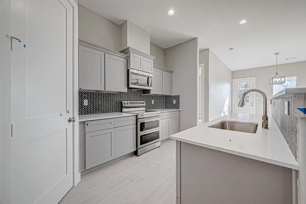 a kitchen with white cabinets and white appliances